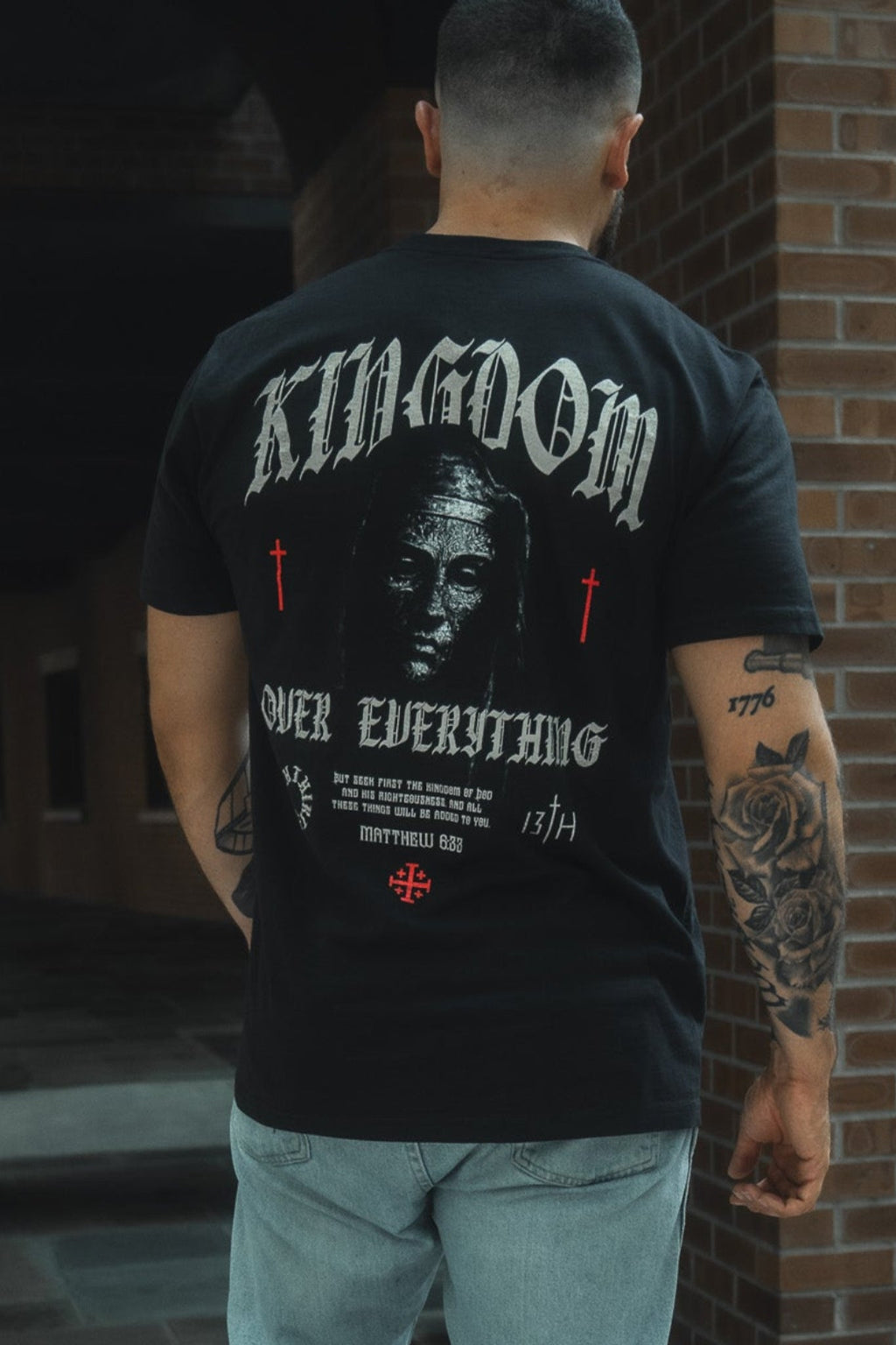 Black premium graphic tee with large back artwork print and text, crew neck.