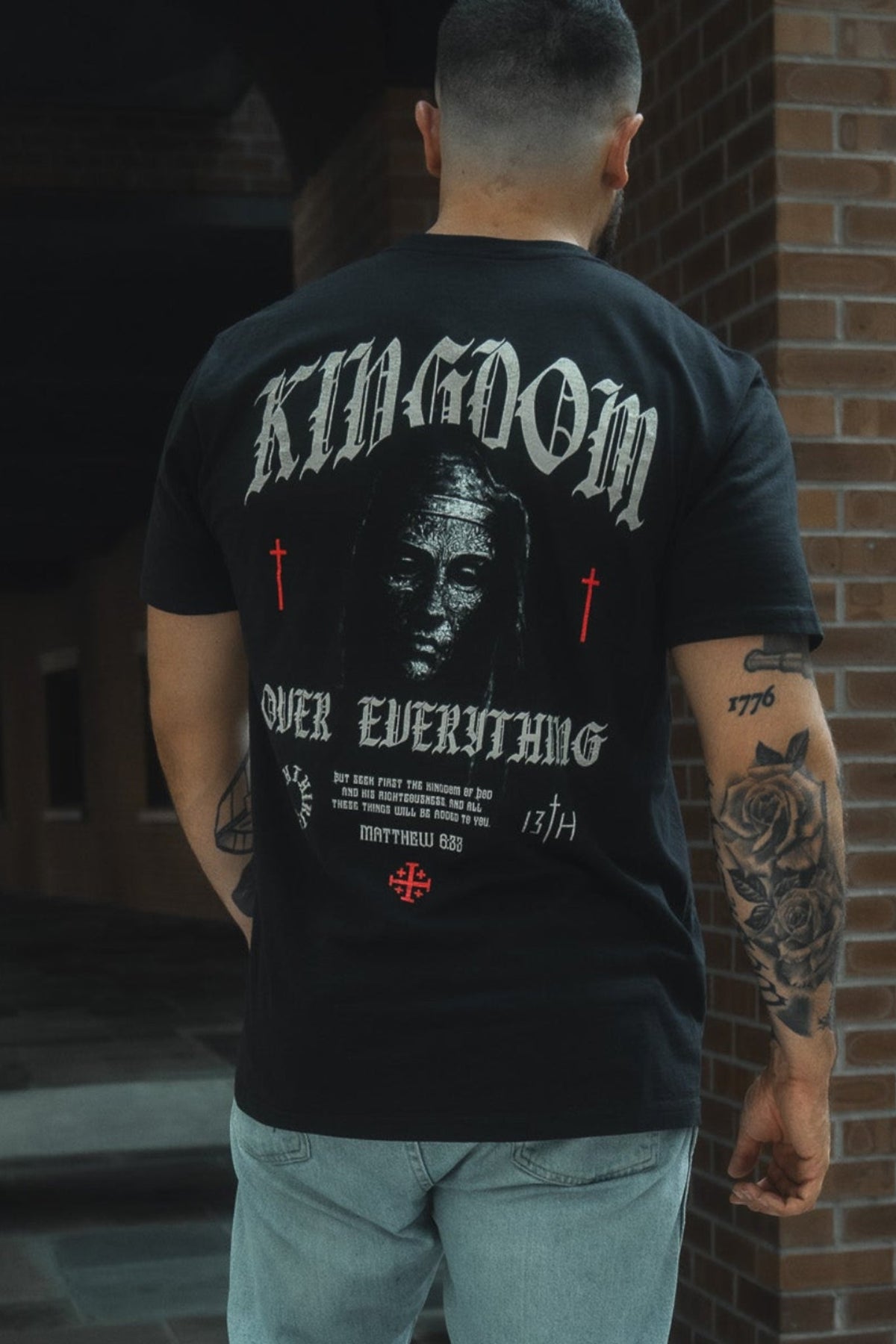 Black premium graphic tee with large back artwork print and text, crew neck.