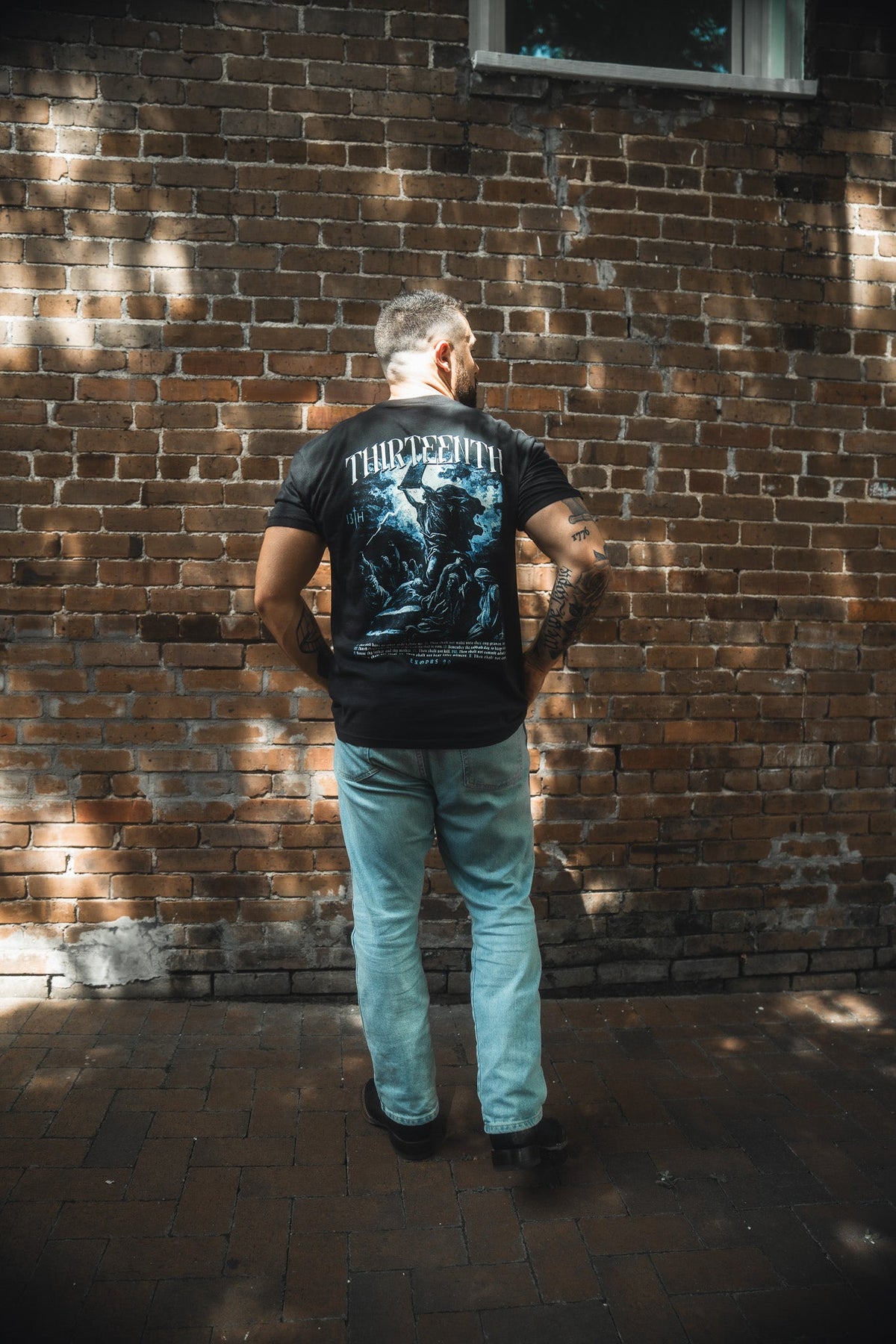 Black premium T-shirt with large blue illustrated back graphic and THIRTEENTH text