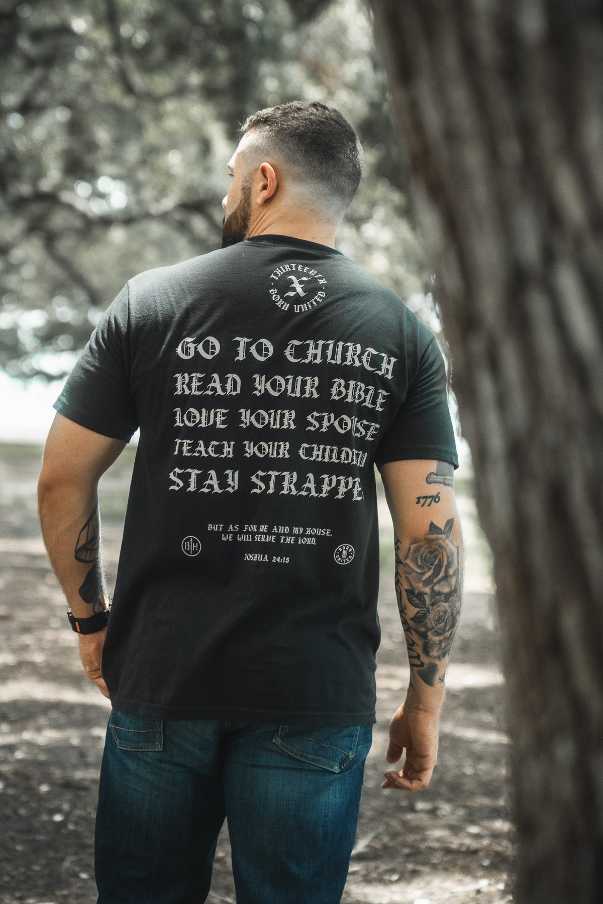Black crewneck T-shirt with large back text graphic in gold tones
