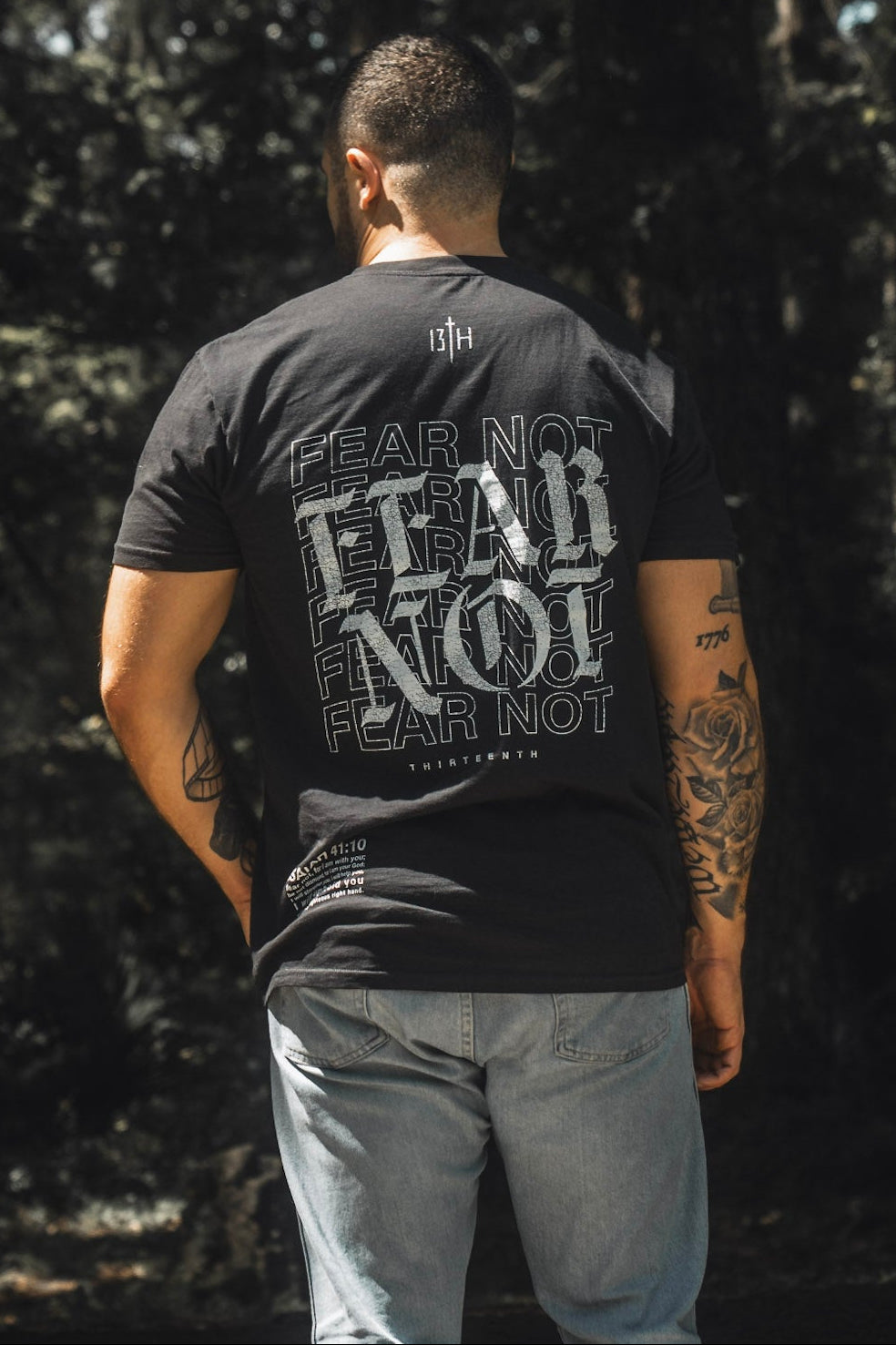 Black premium tee with large back “FEAR NOT” graphic text