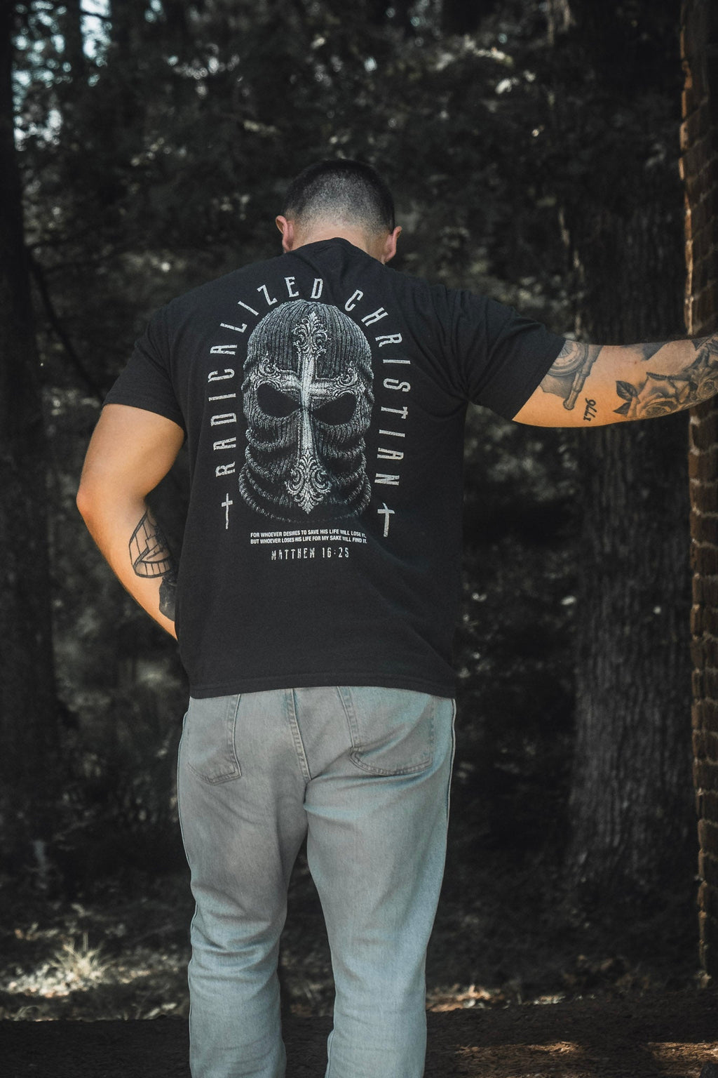 Black premium tee with large back skull cross graphic and circular text