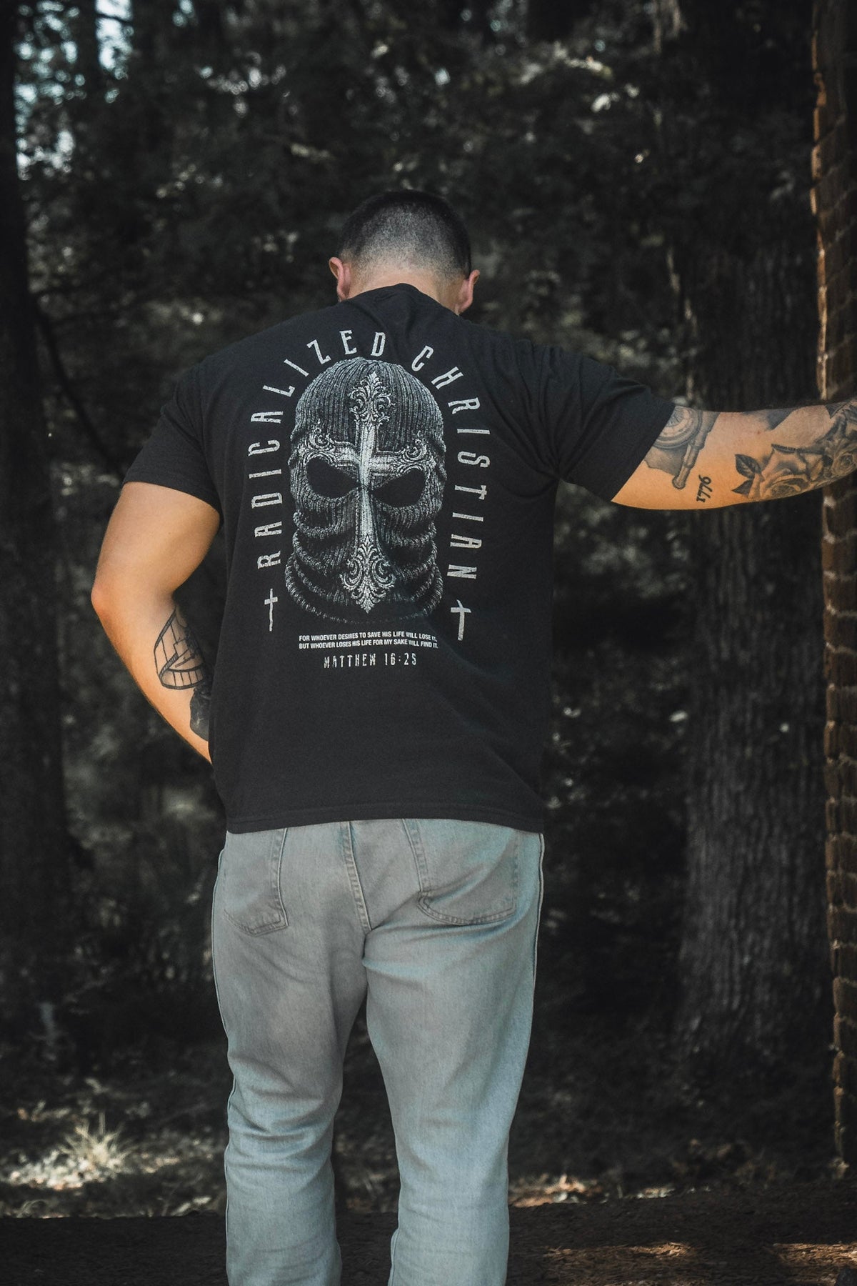 Black premium tee with large back skull cross graphic and circular text