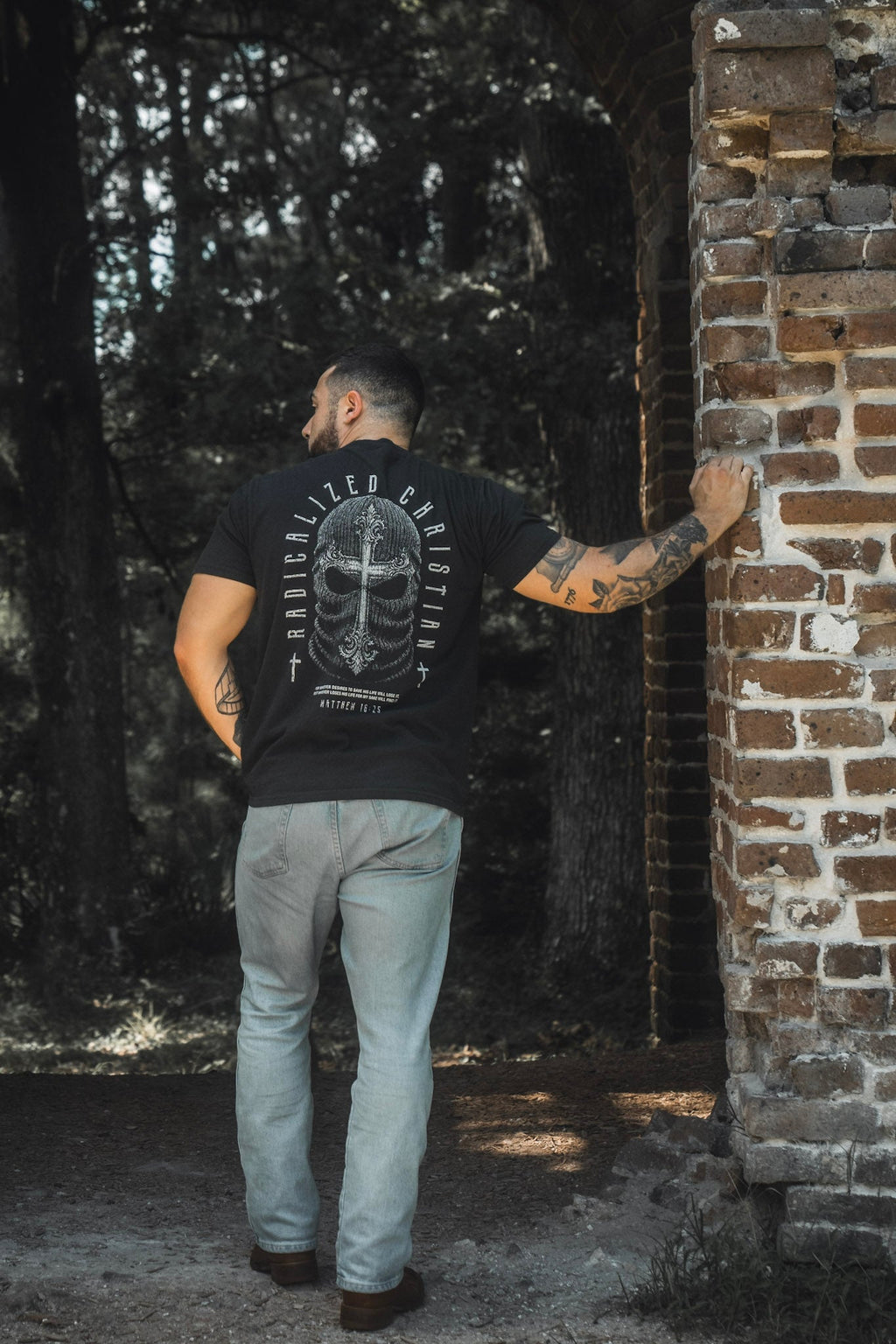 Black premium tee with large back skull cross graphic and circular text