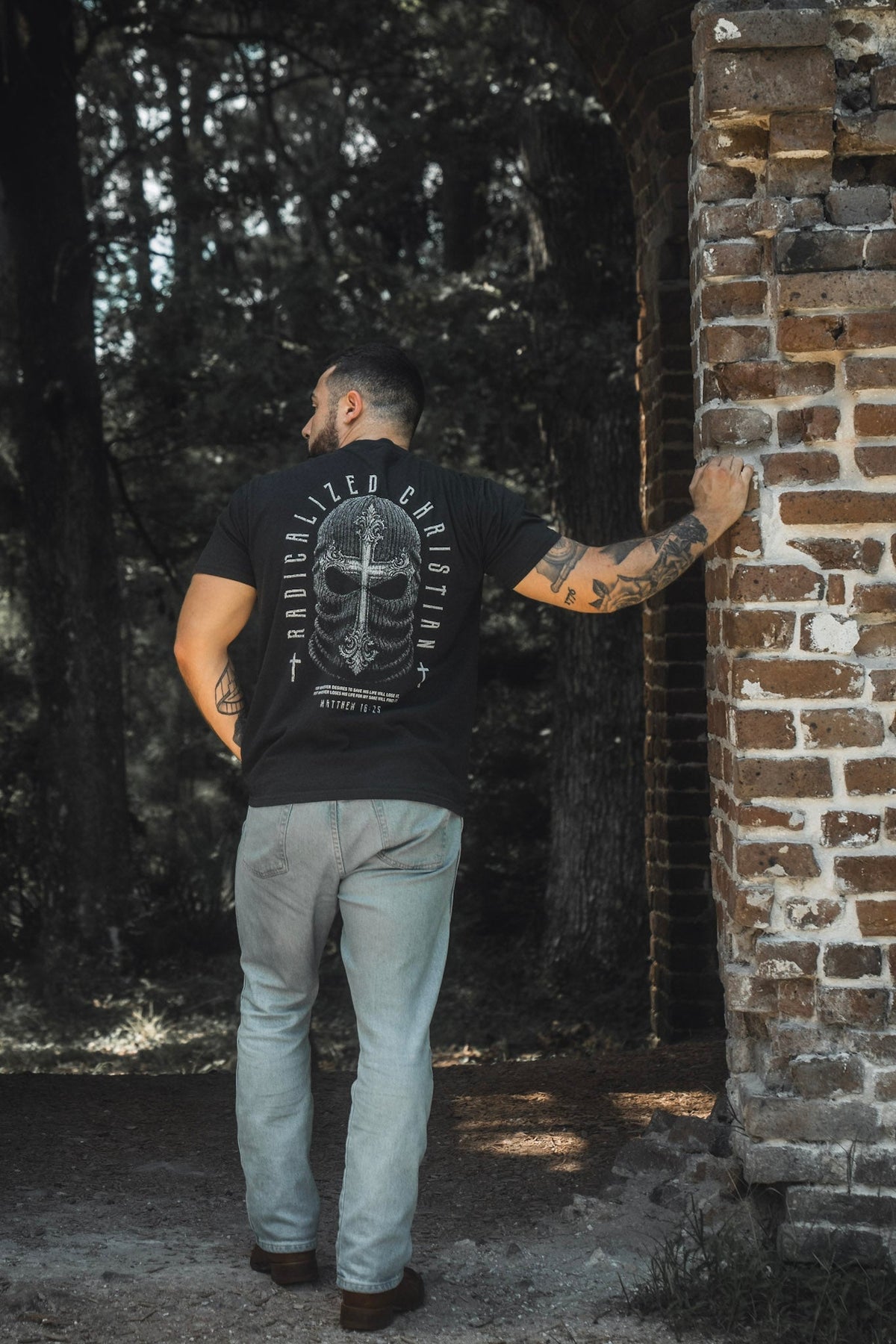 Black premium tee with large back skull cross graphic and circular text