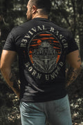 Black tee, back graphic circular emblem with orange stripes and gray farm illustration