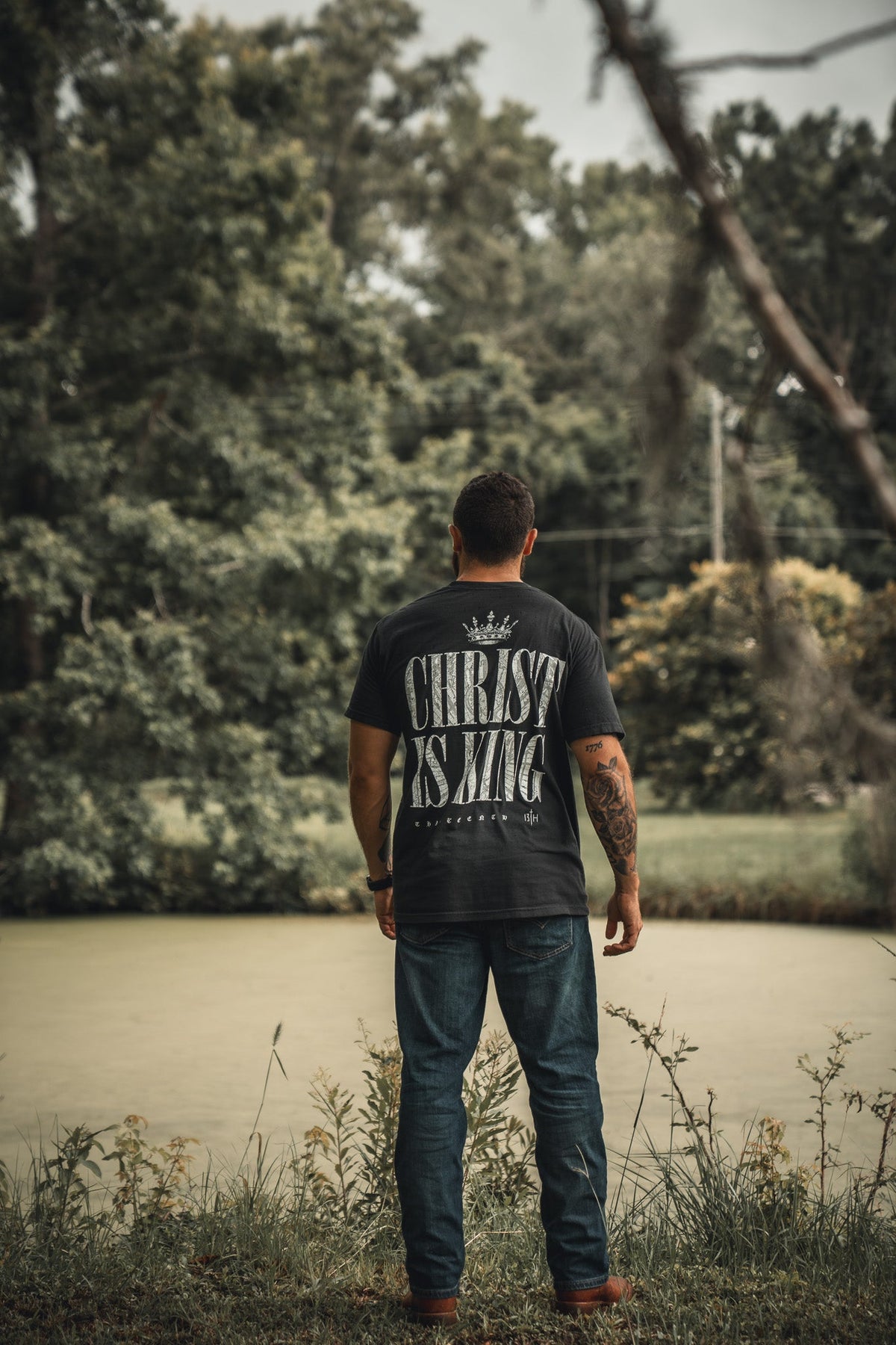 Black T-shirt with back "CHRIST IS KING" text and small crown above