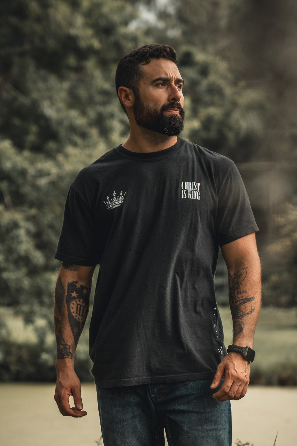 Black T-shirt with small chest crown logo and "CHRIST IS KING" text