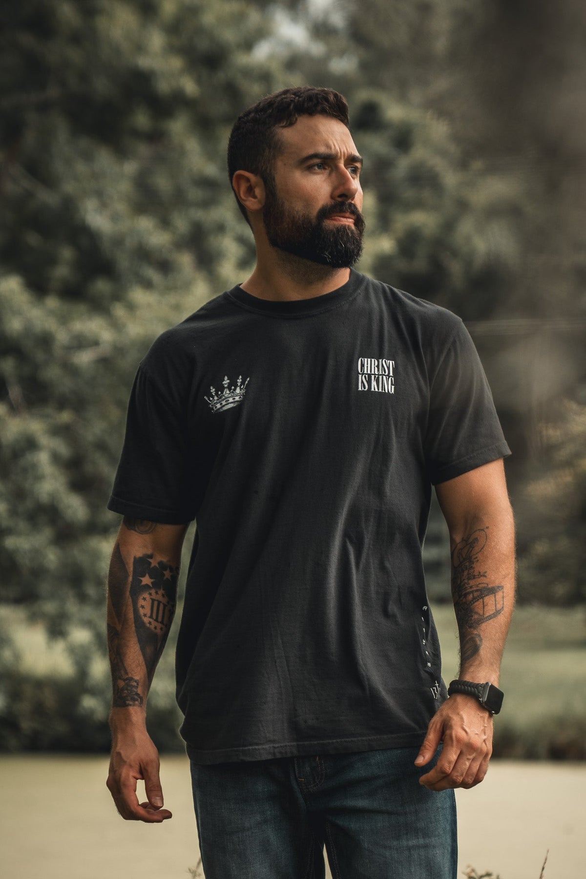 Black T-shirt with small chest crown logo and "CHRIST IS KING" text