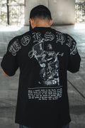 Black oversized tee with large back graphic and ornate white-and-gray lettering.