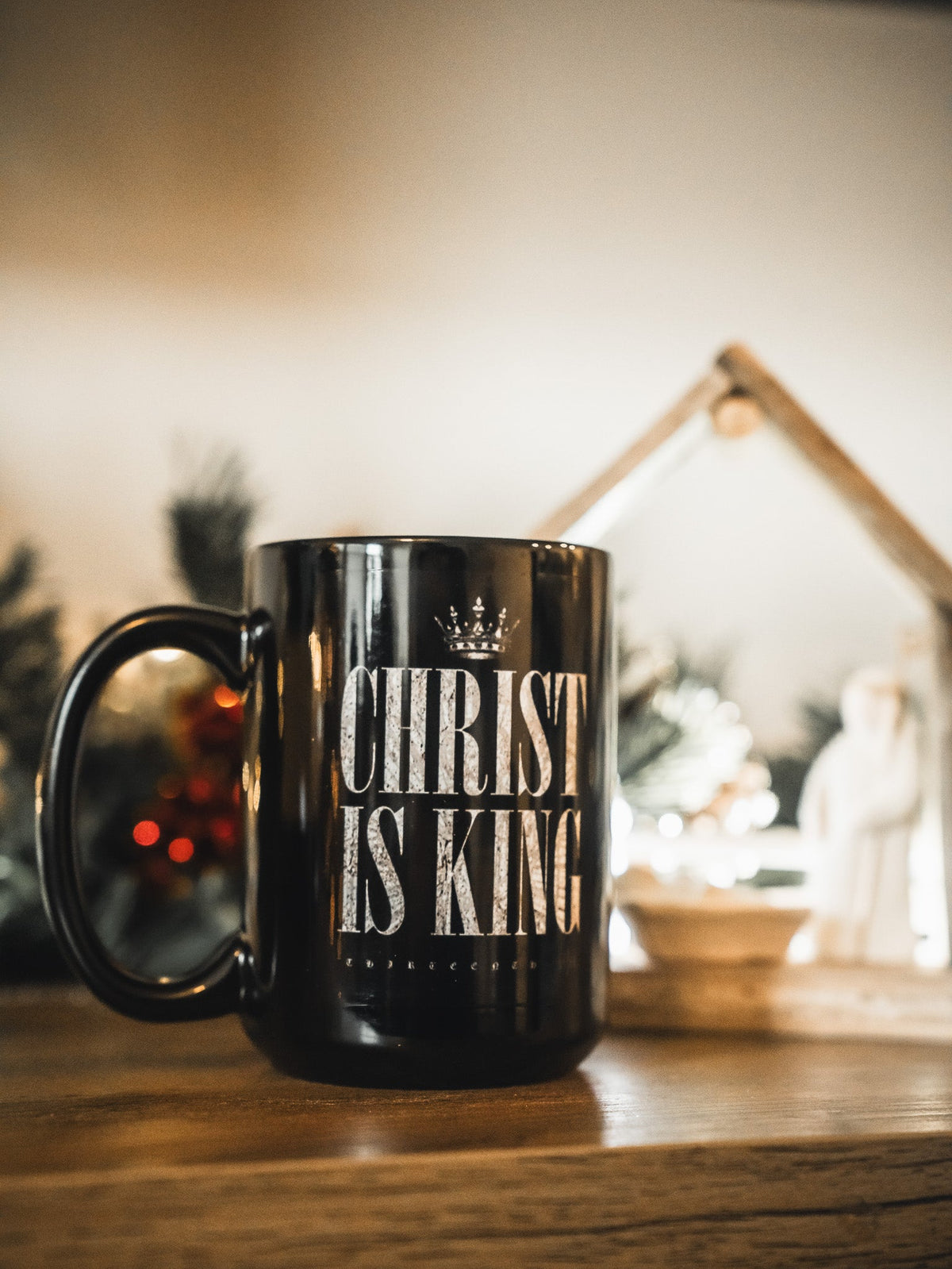Black mug with crown-style CHRIST IS KING lettering