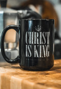 Black mug with "Christ Is King" text and crown graphic