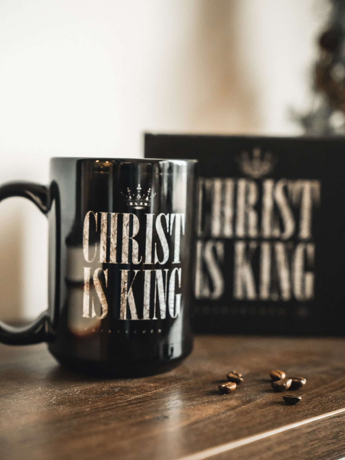 Close-up of black mug showing CHRIST IS KING lettering