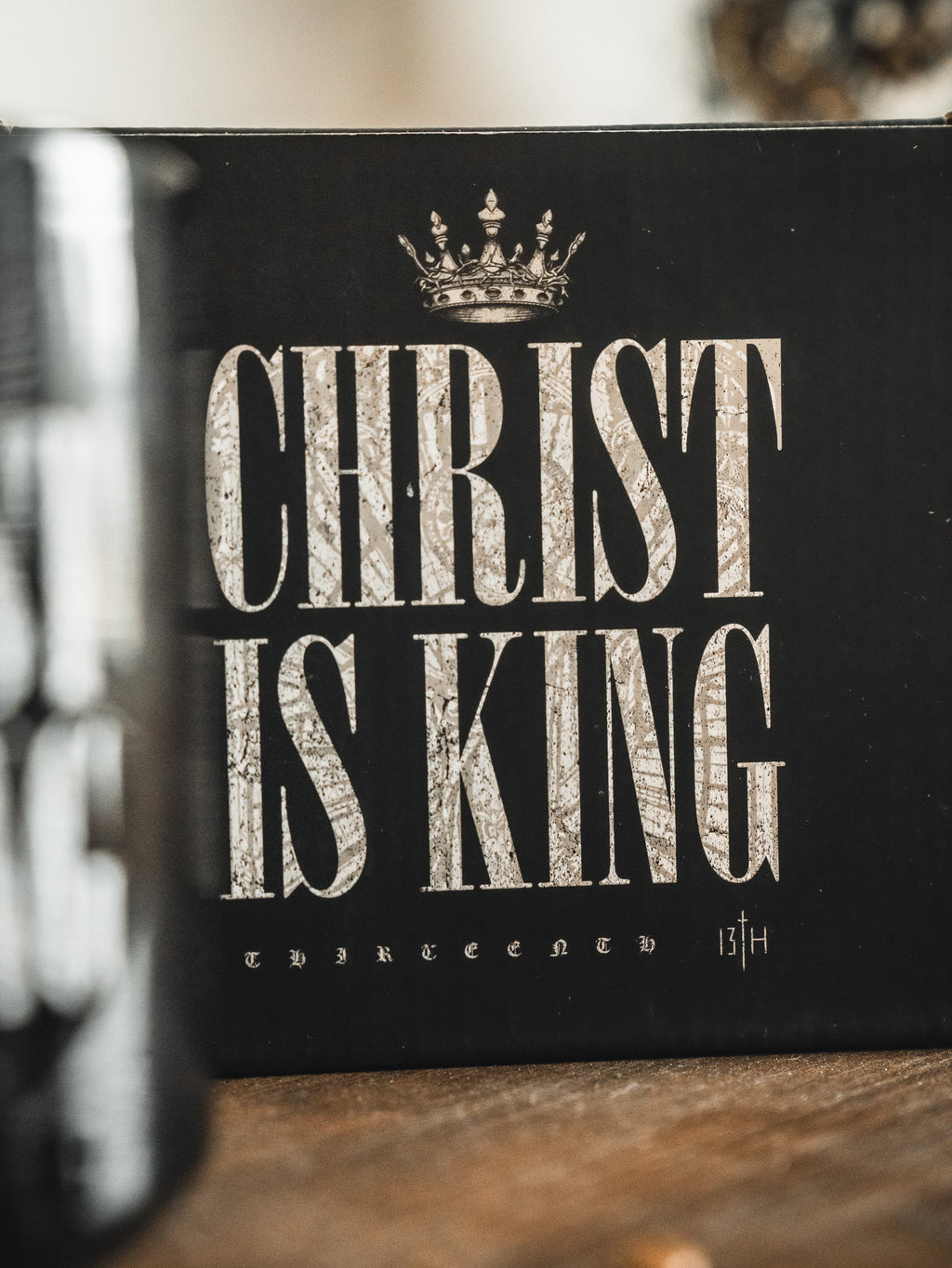 Black mug with large white CHRIST IS KING typography and crown icon