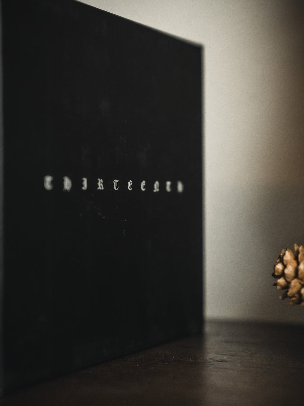 Dark gift box corner with small gold text centered on the panel
