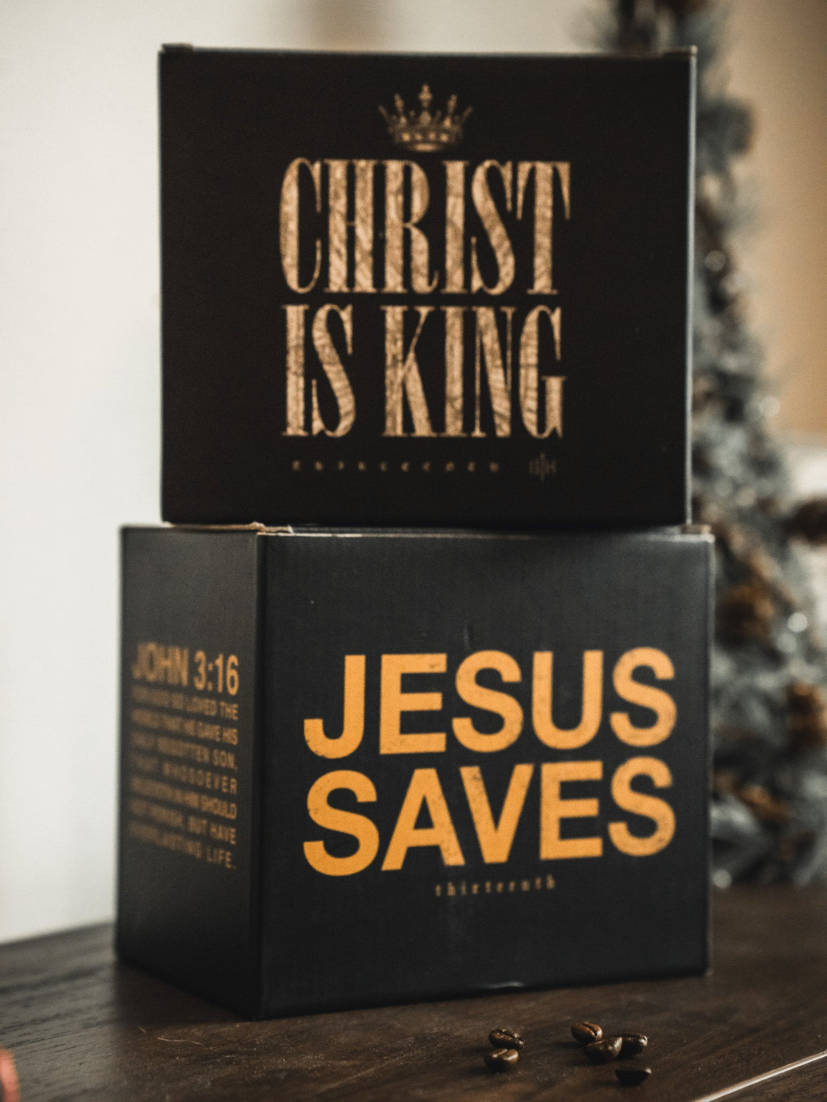 Stacked black gift boxes with CHRIST IS KING and JESUS SAVES text