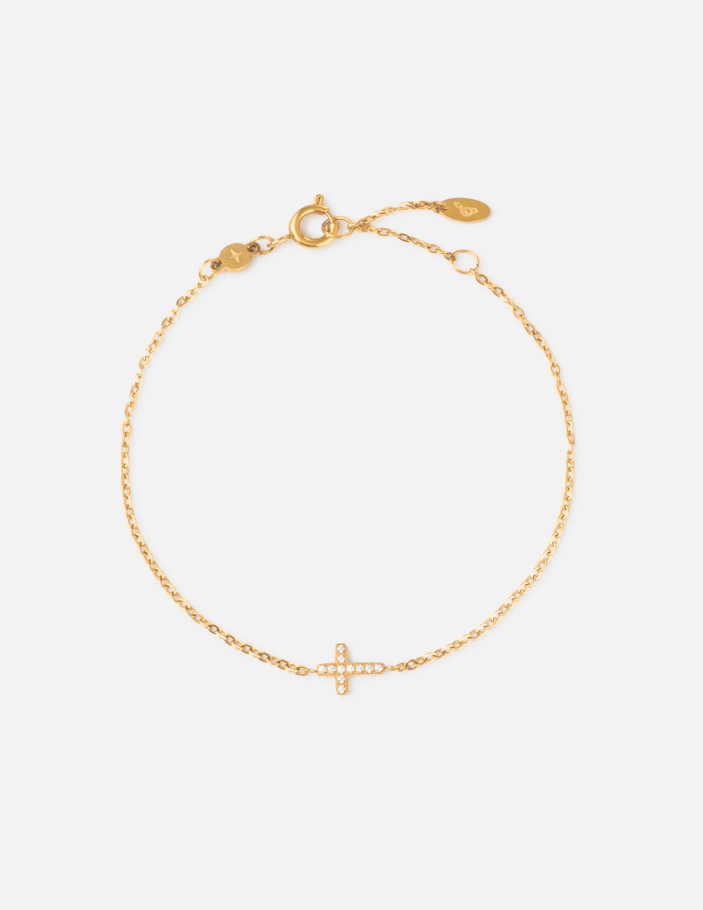Gold link bracelet with small cross charm and adjustable lobster clasp.