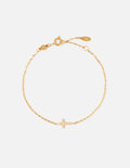 Gold link bracelet with small cross charm and adjustable lobster clasp.
