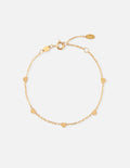 Gold charm bracelet with heart and round beads on a fine chain