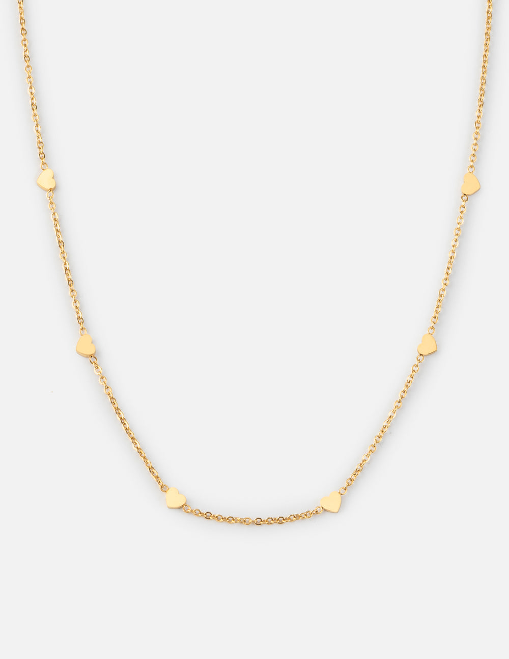 Gold tone link necklace with small heart charms and short extender chain