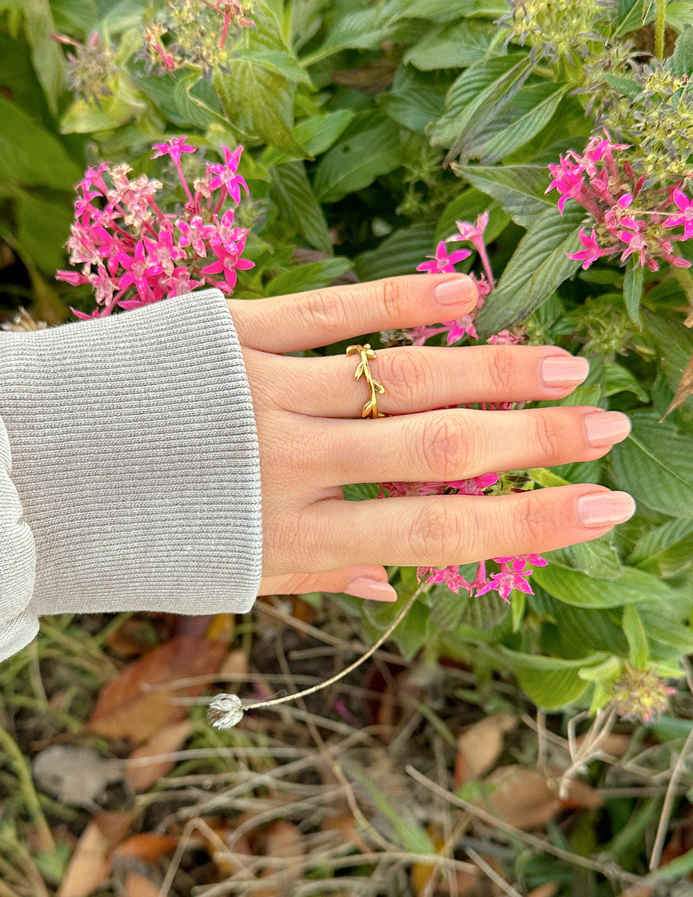 Gold-tone olive branch ring with raised vine leaf motif on an open band