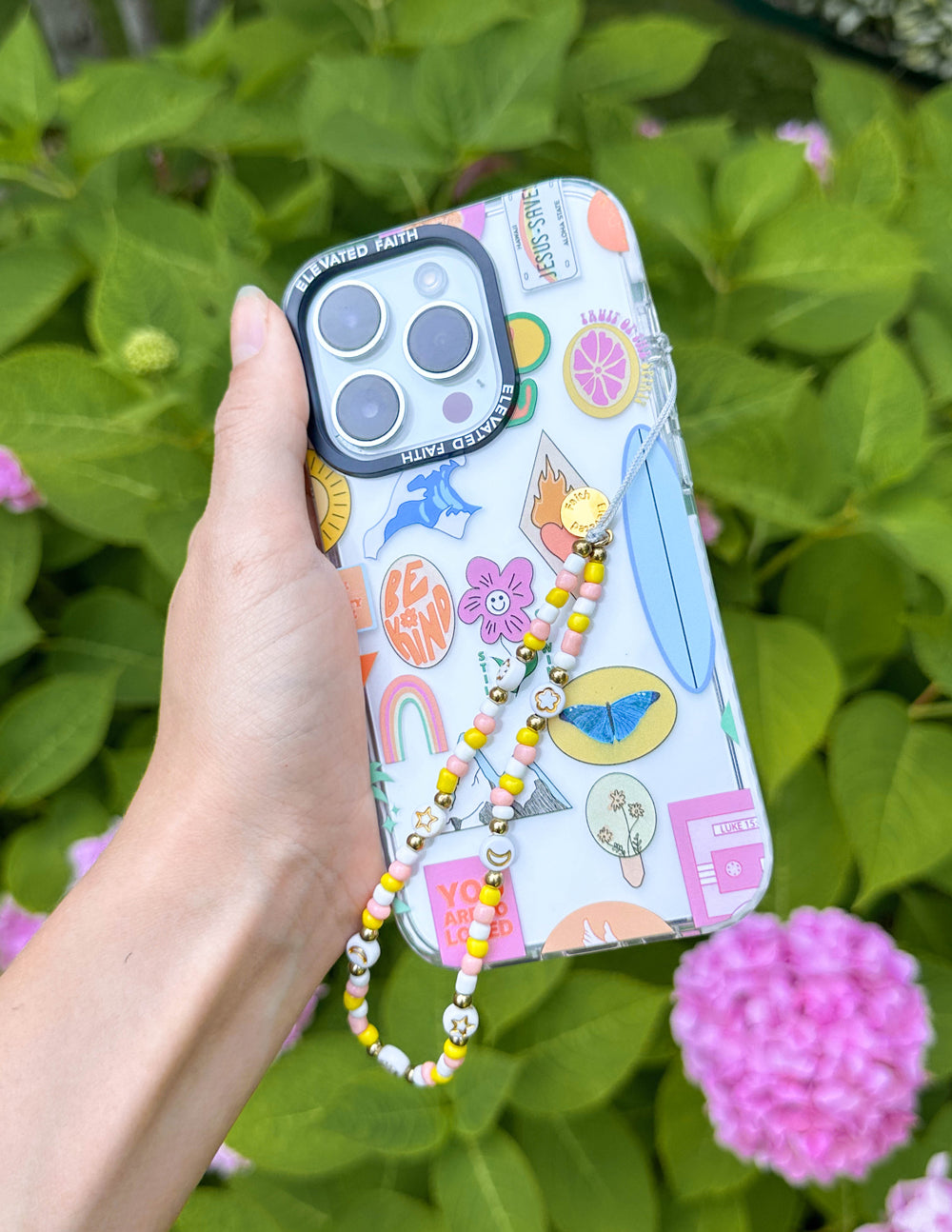 Beaded phone charm with yellow and white beads on blue phone case