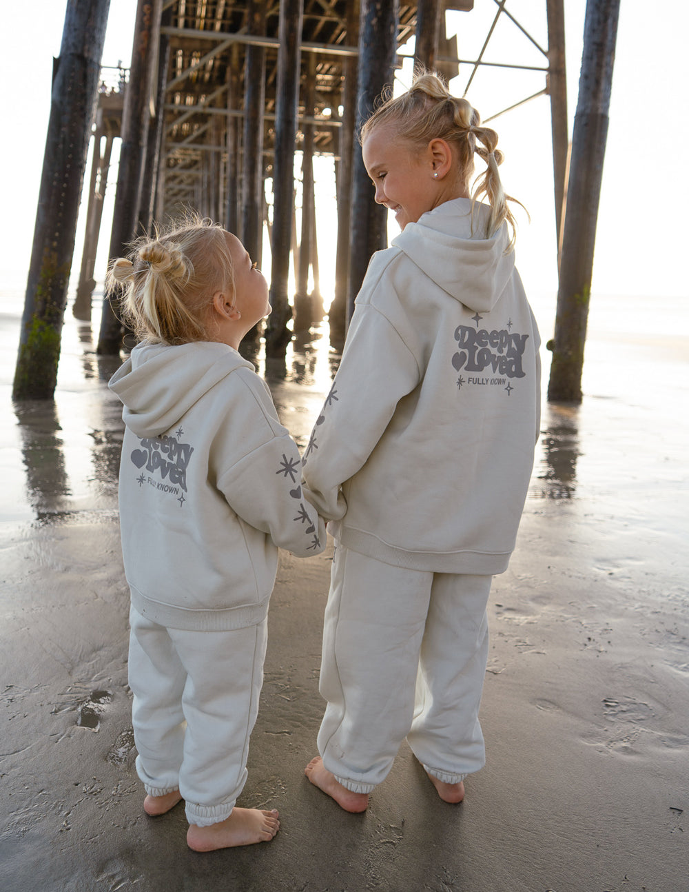 Kids hoodie off-white on two children with back “Sleepy Loved” graphic