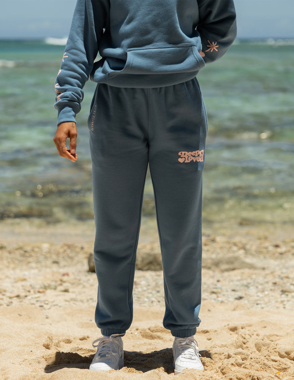 Unisex blue sweatpants with thigh graphic and cuffed jogger-style legs