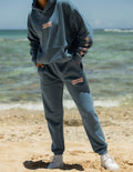 Unisex sweatpants in blue with graphic print on thigh and relaxed tapered legs