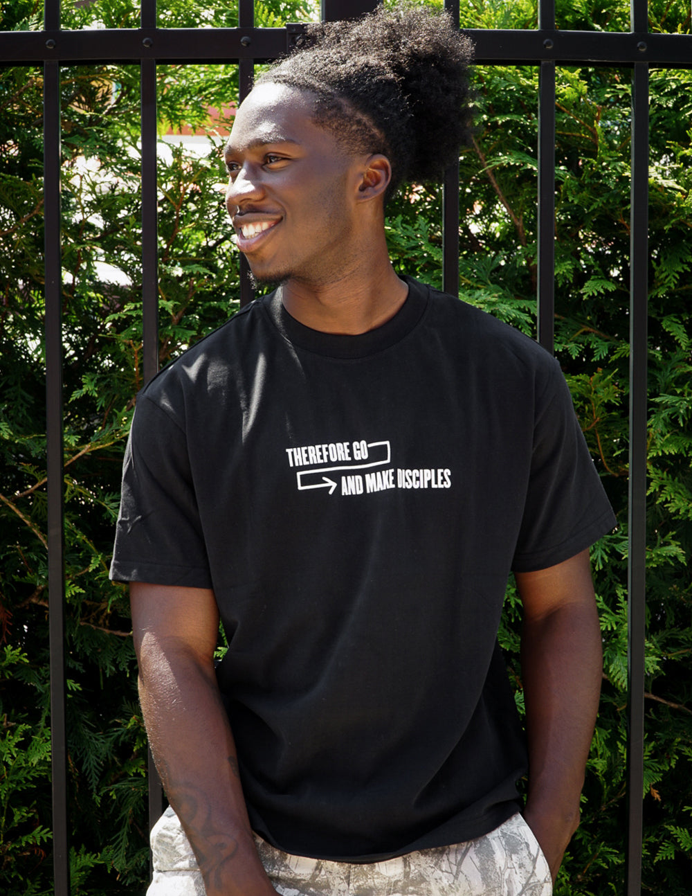Unisex T-shirt, black, with centered small white arrow-and-text graphic