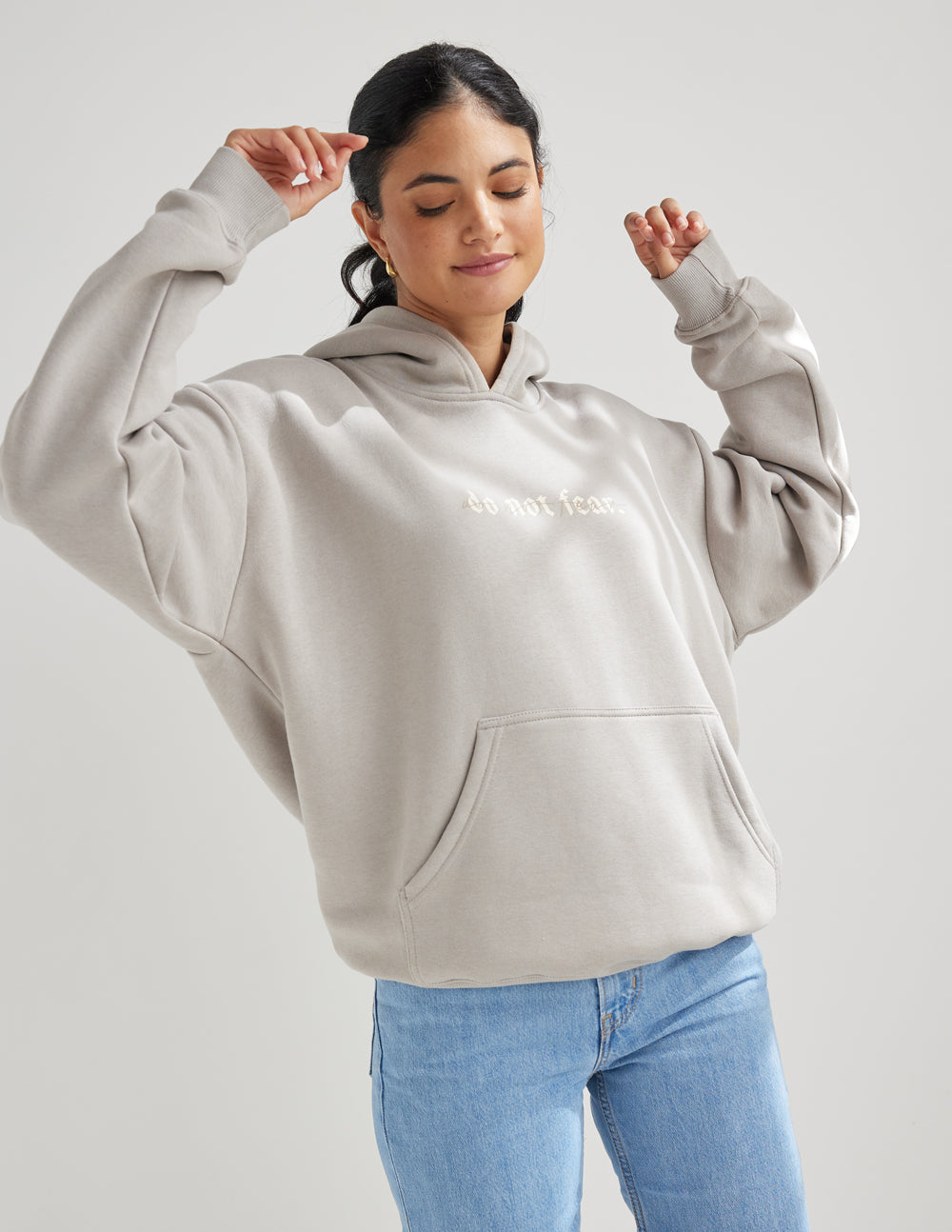 Grey unisex hoodie with hood, kangaroo pocket and small chest text