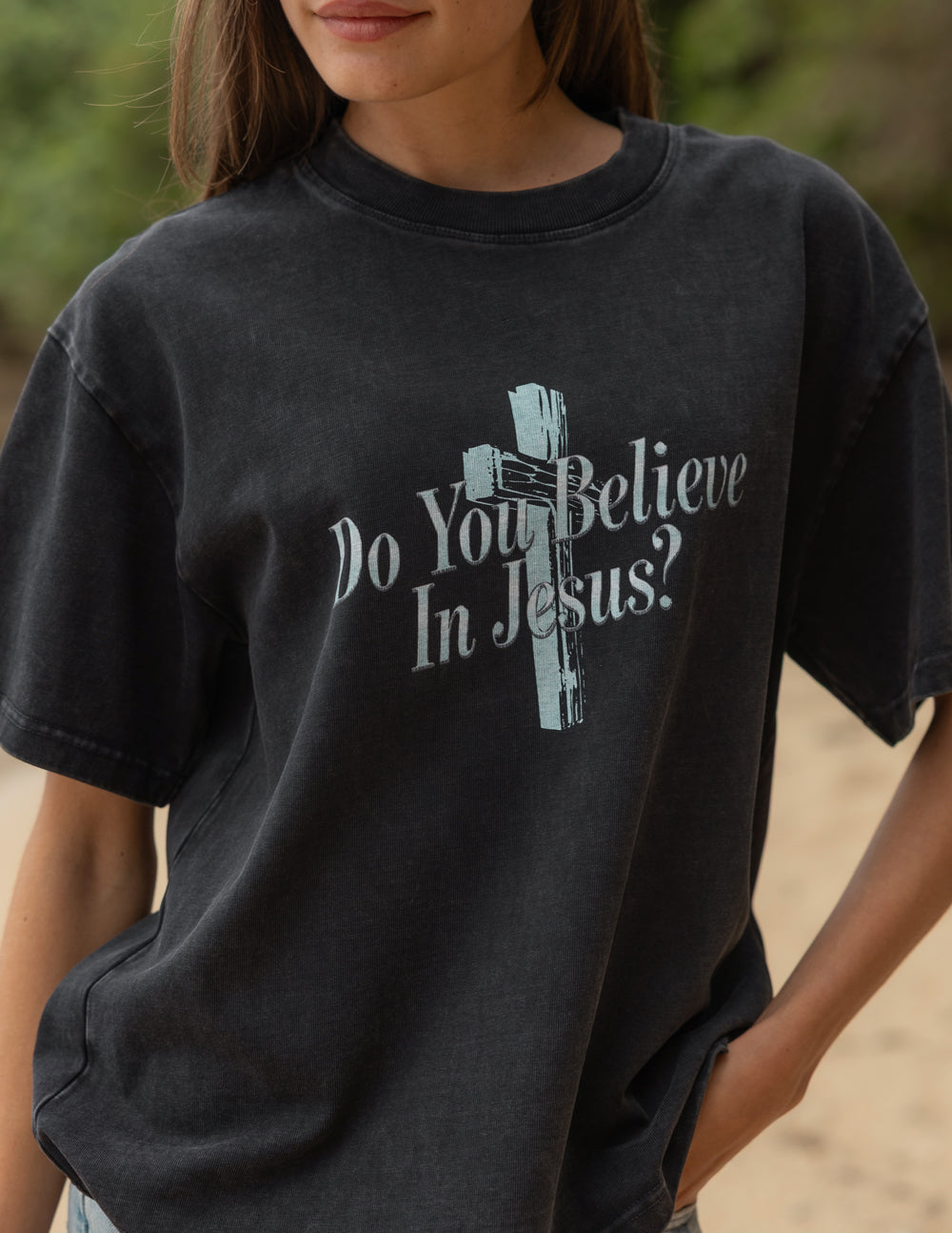 Black crewneck tee with front cross graphic and “Do You Believe In Jesus?” text.