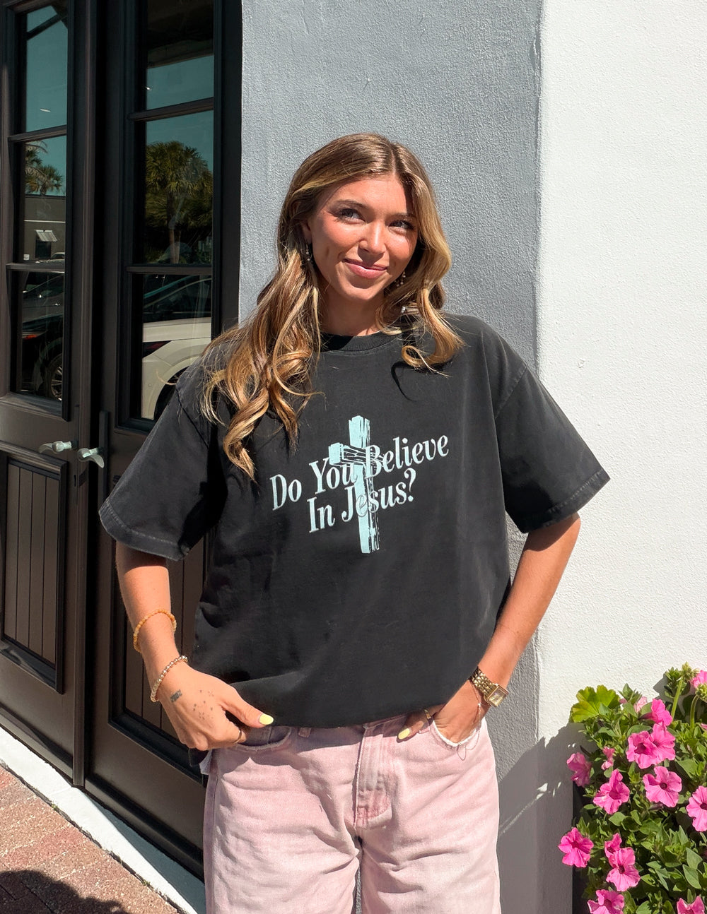 Black crewneck tee with front cross graphic and “Do You Believe In Jesus?” slogan.