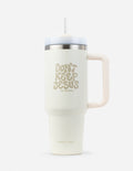 Cream 40 oz insulated tumbler with silver lid, straw, and side handle