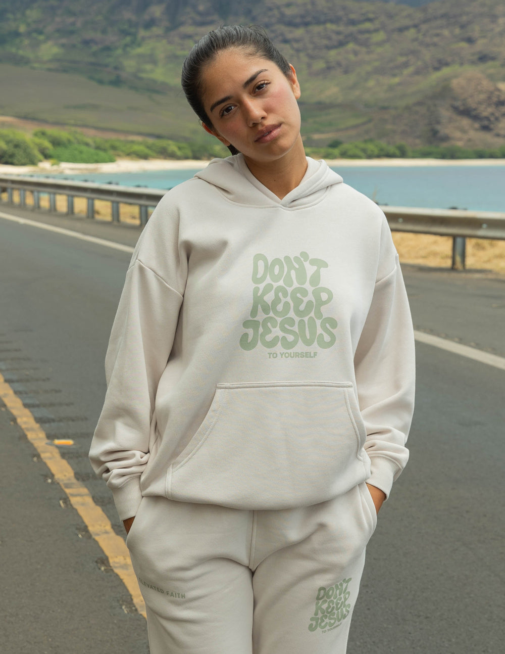 Cream unisex hoodie with green "DON'T KEEP JESUS" text graphic, hood and kangaroo pocket
