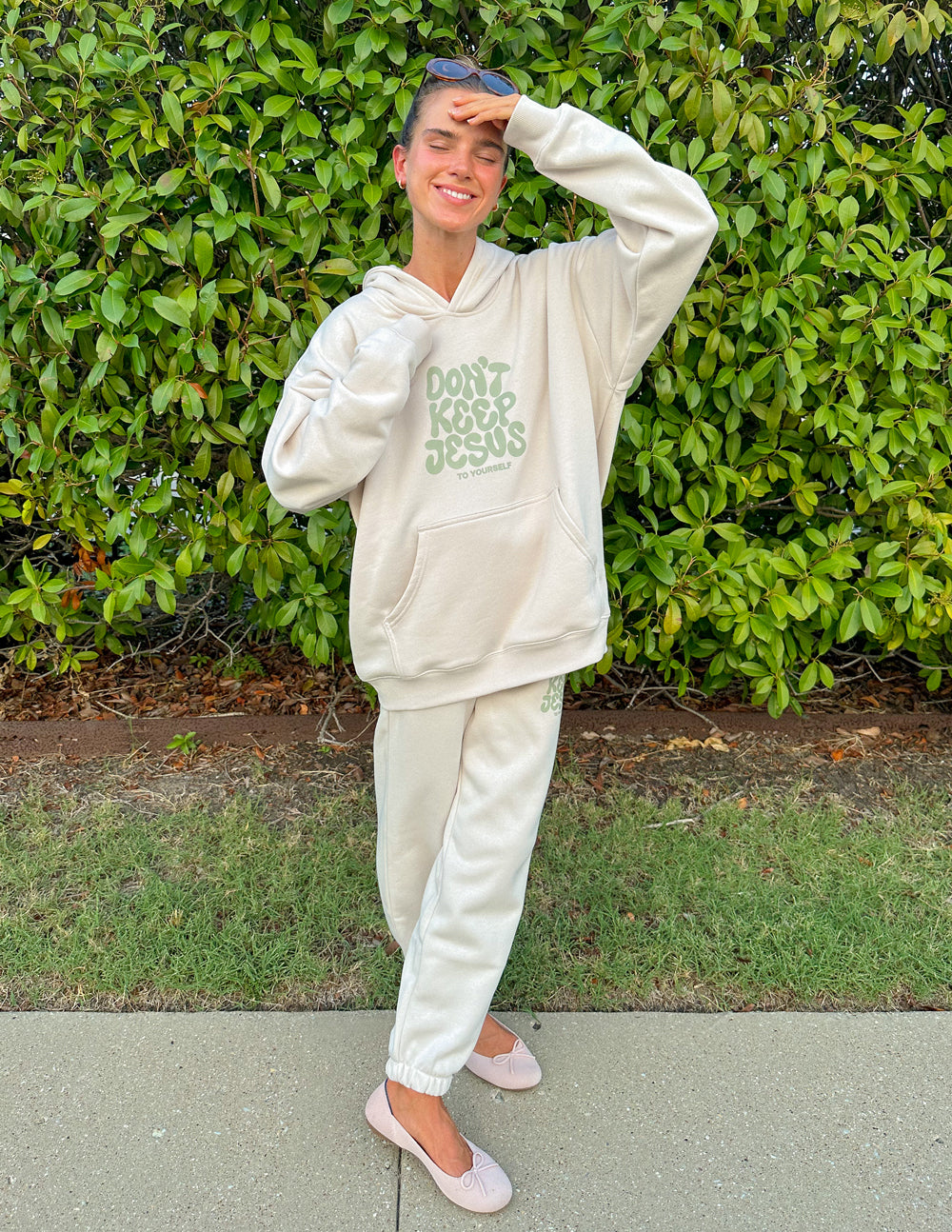 Cream unisex hoodie with green "DON'T KEEP JESUS" graphic, hood with drawstring and front pocket
