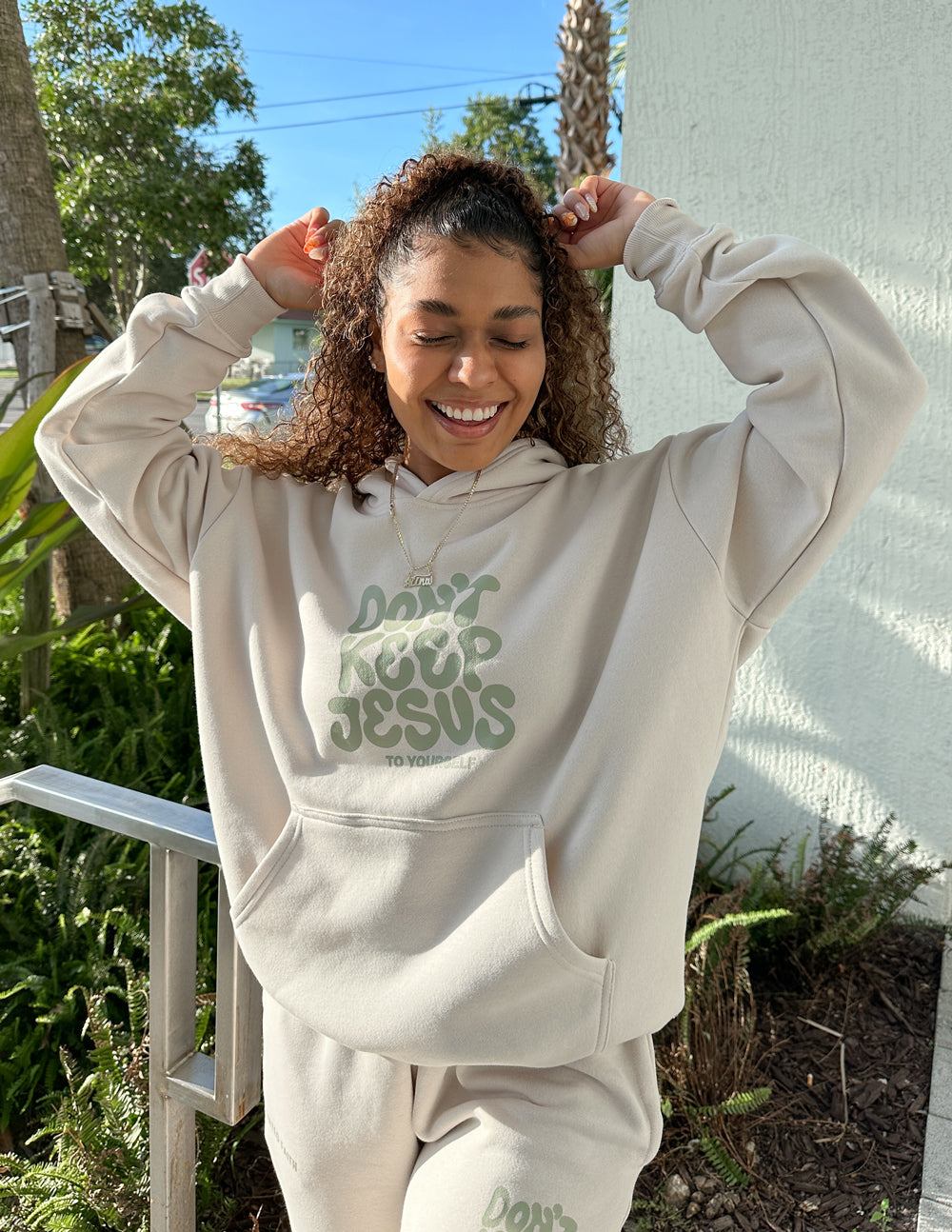 Cream unisex hoodie with green "DON'T KEEP JESUS" graphic, hood and front kangaroo pocket