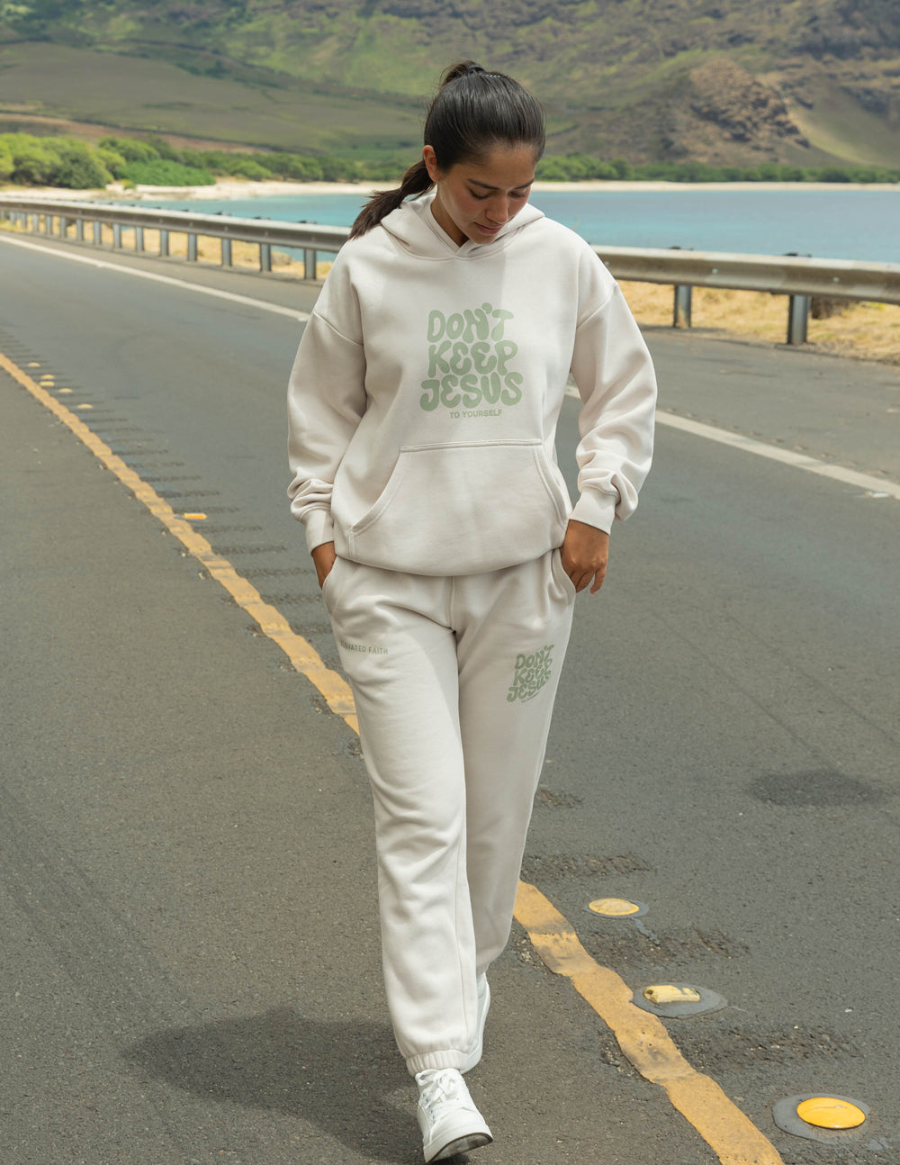 Cream unisex sweatpants with green logo print and cuffed ankle hem