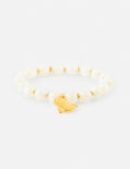 White pearl beaded bracelet with a centered gold dove charm