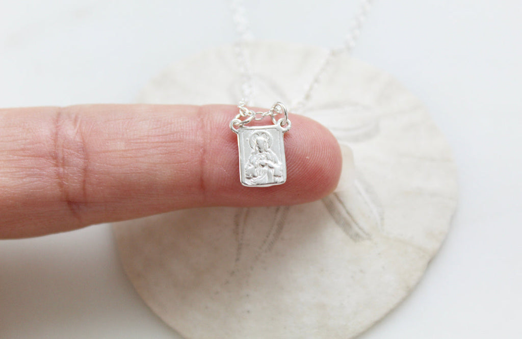 Sterling silver scapular necklace with small engraved rectangular pendant, side view