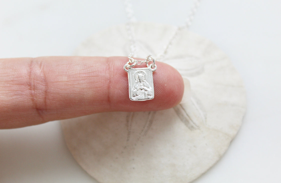 Sterling silver scapular necklace with small engraved rectangular pendant, side view