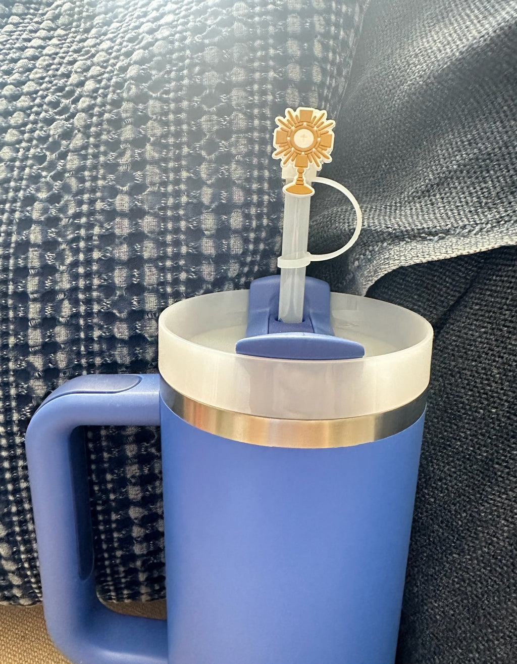 Gold Adoration straw topper with cross and chalice on blue straw, close-up
