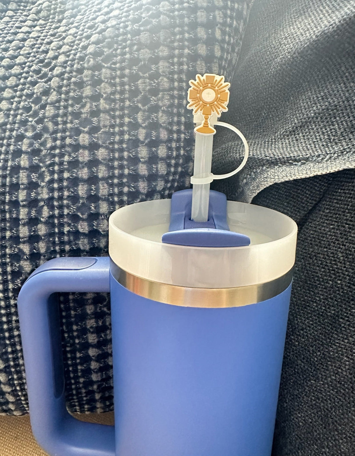 Gold Adoration straw topper with cross and chalice on blue straw, close-up