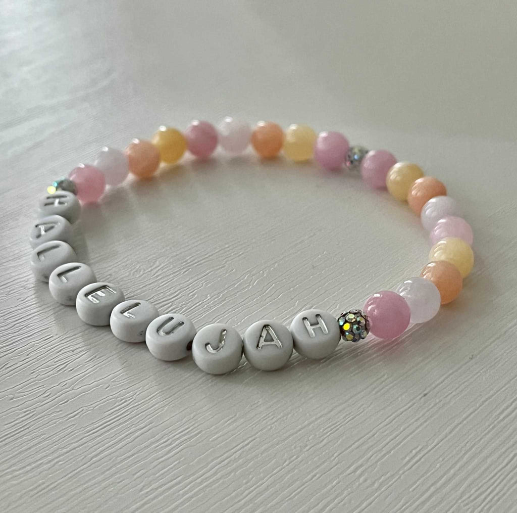 Beaded bracelet with pastel beads, silver letters spelling HALLELUJAH, and flower accent bead