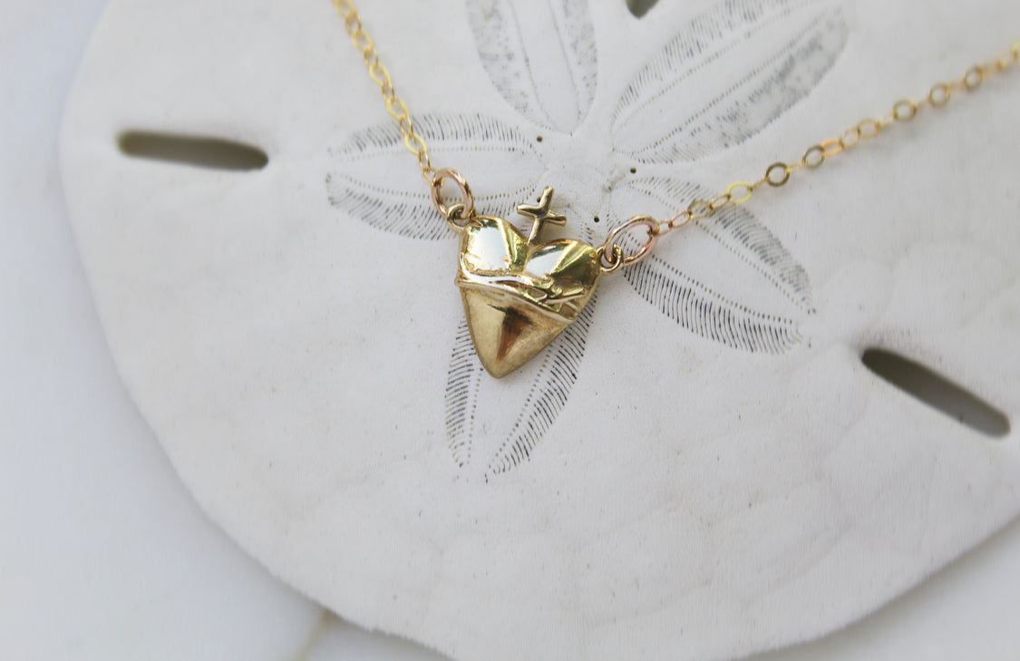Gold-tone triangle heart charm necklace with cross on thin chain
