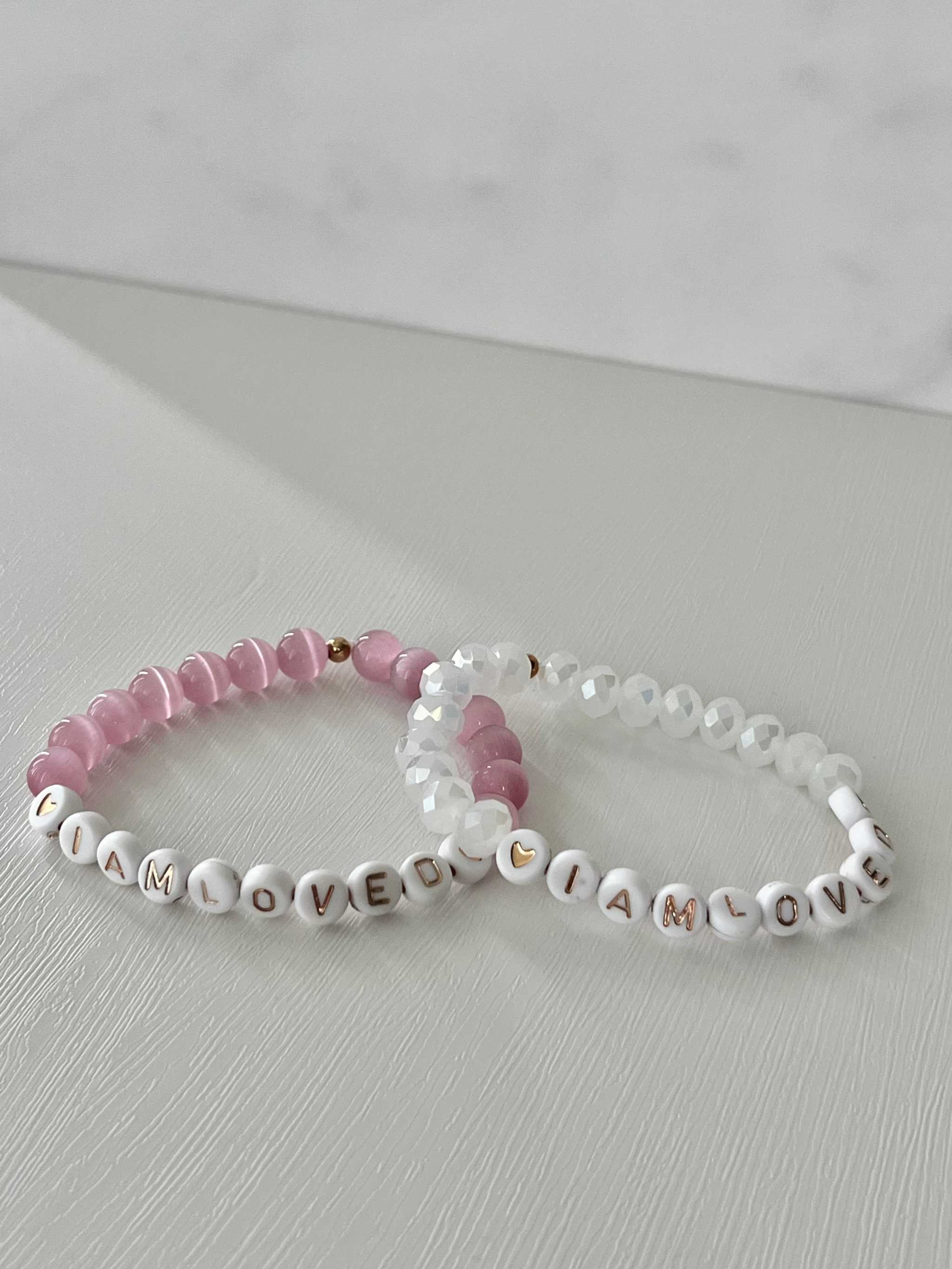 Pink and white beaded bracelet with 'I AM LOVED' letter beads and crystal accents