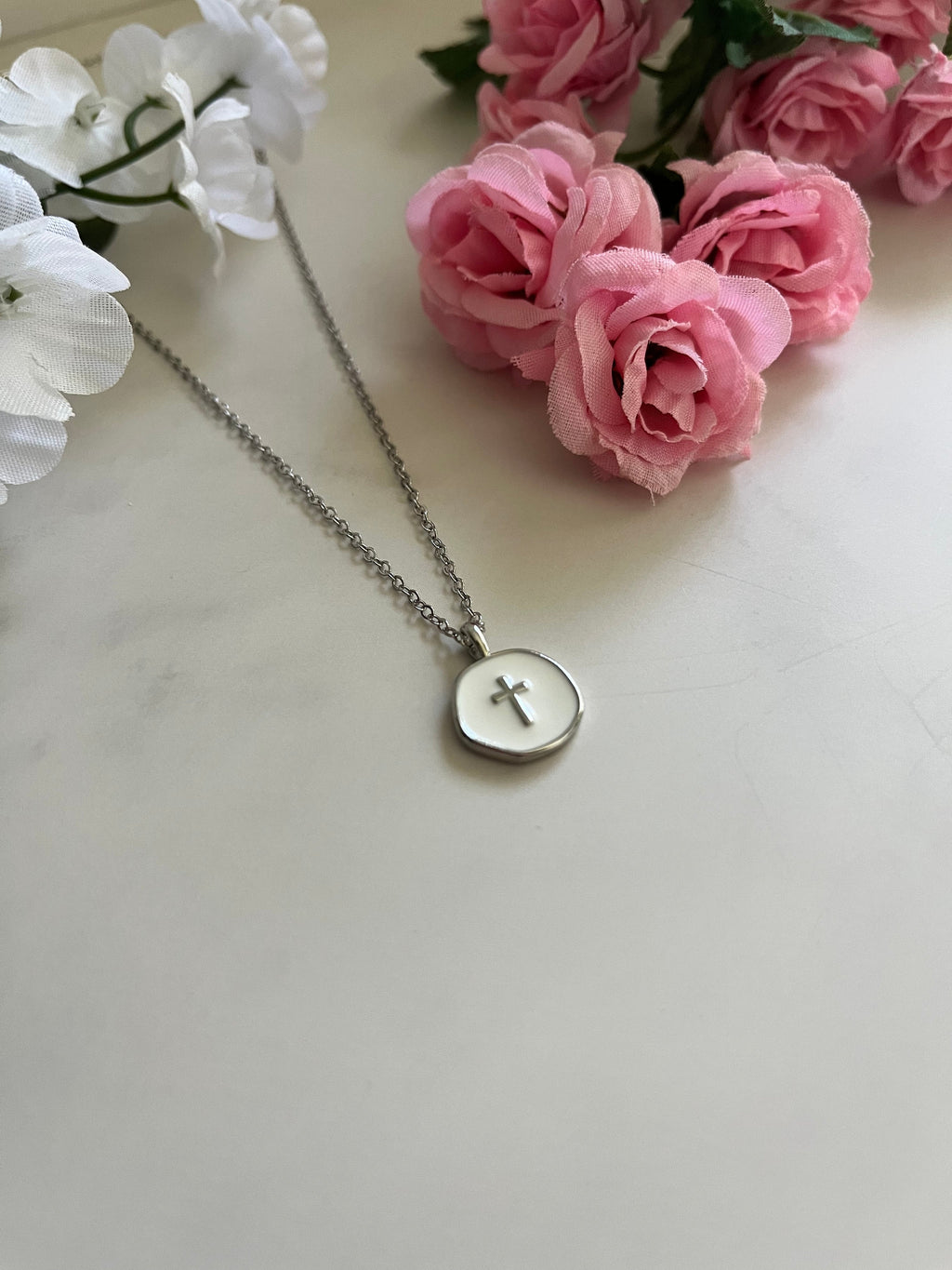 Silver necklace with round pendant engraved with a cross