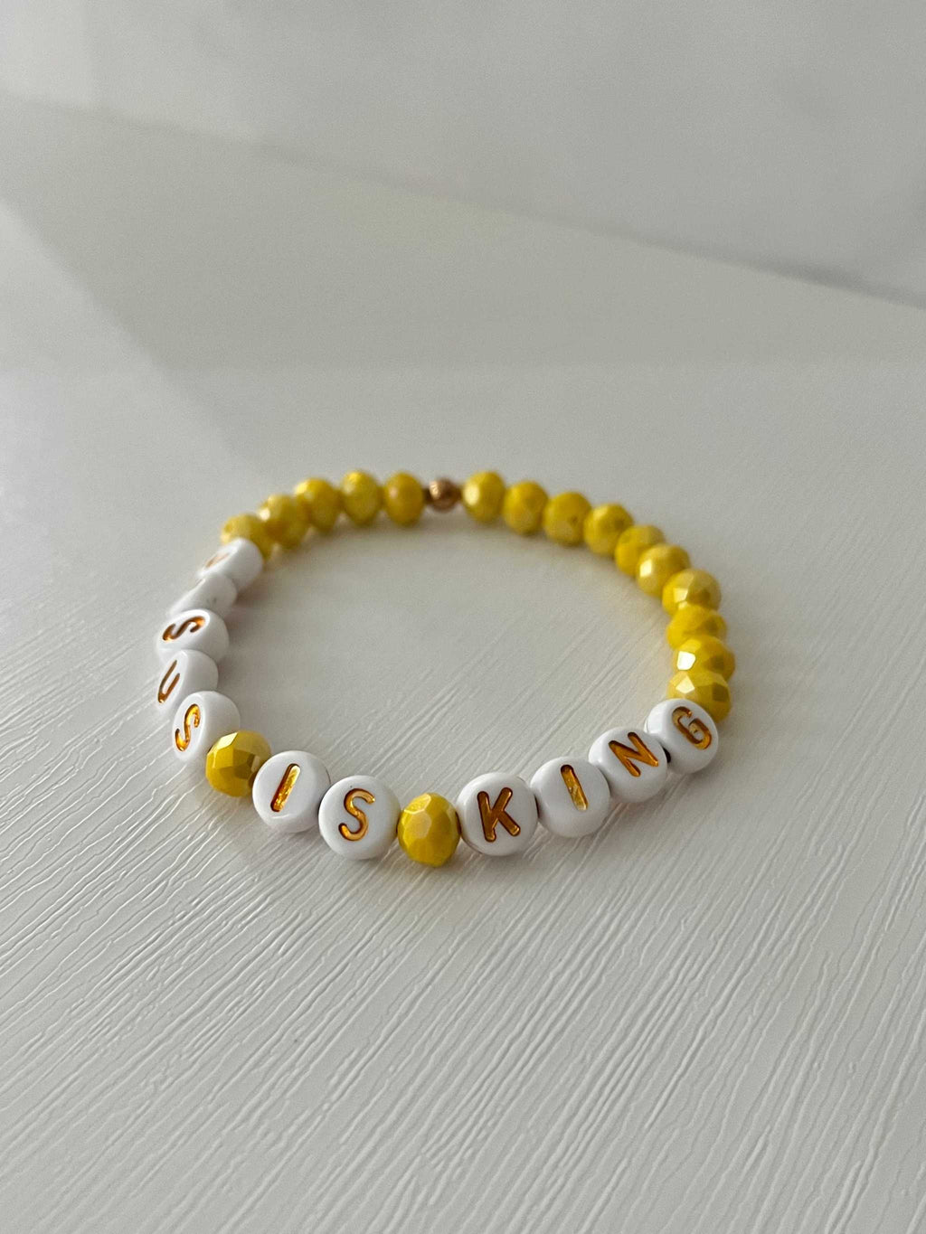 Bead bracelet with white letter beads and yellow round beads, JESUS KING