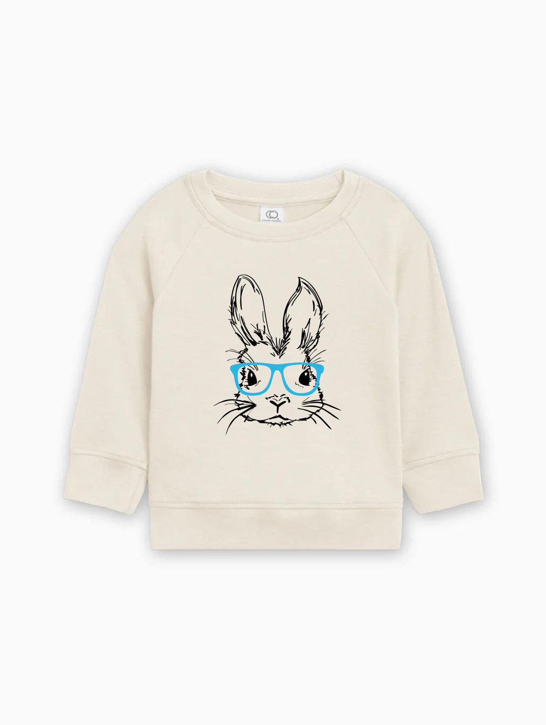 Baby pullover with bunny graphic wearing blue glasses, cream