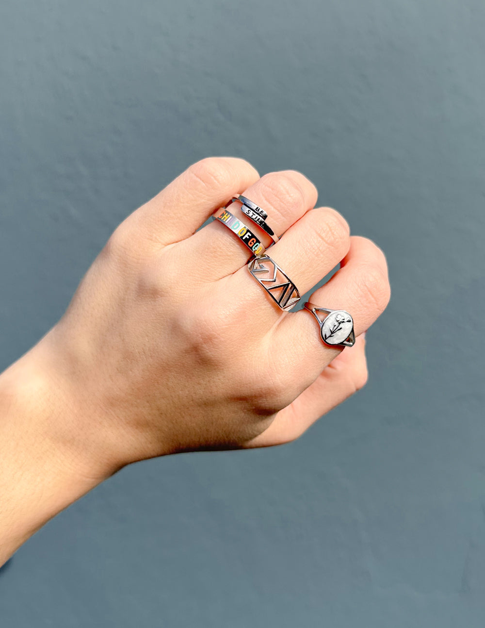 Silver geometric statement ring worn on finger